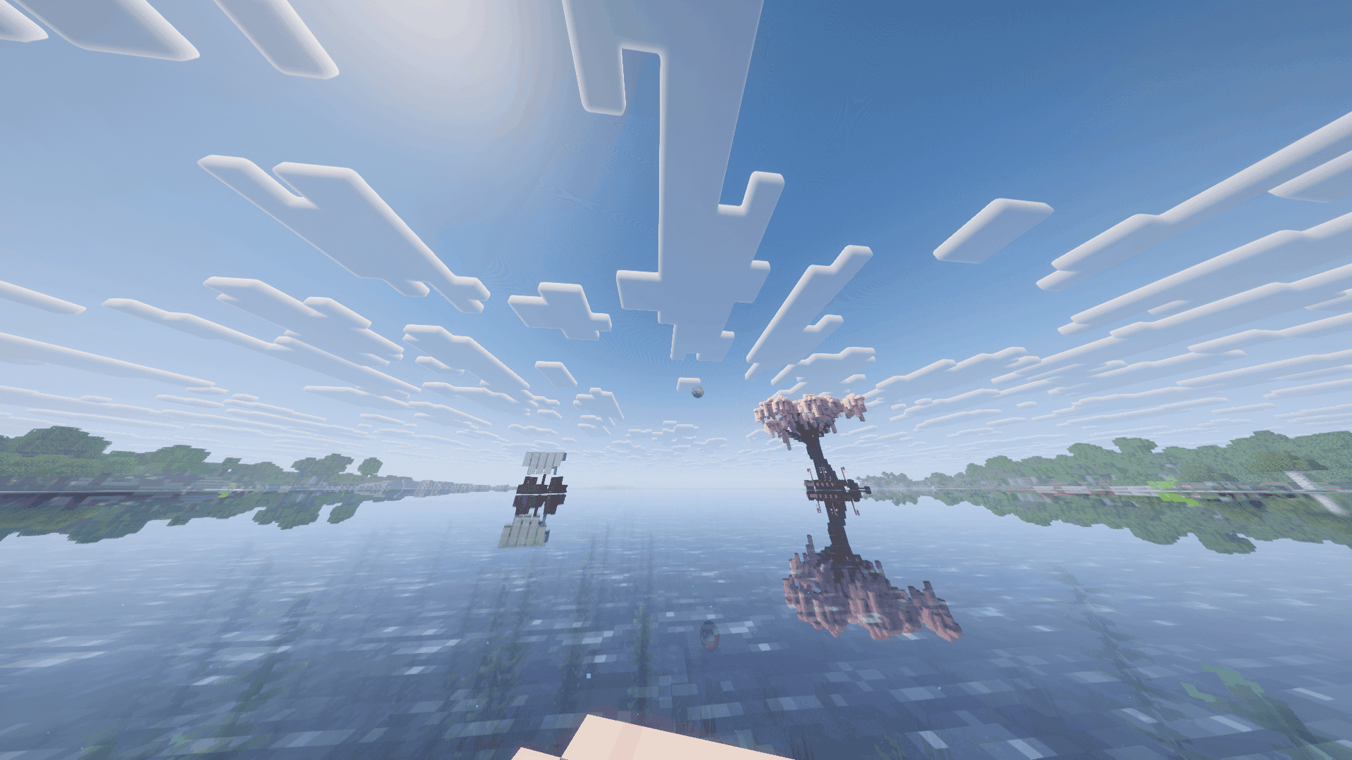 The great tree and eyeball structures across reflective water